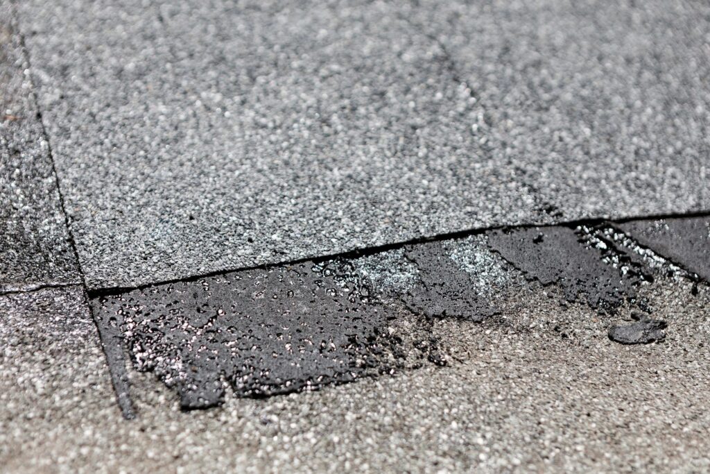 Worn patch of roof with visible signs of repair