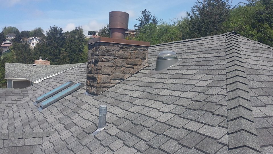 A close up view of a roof with grey shingles.