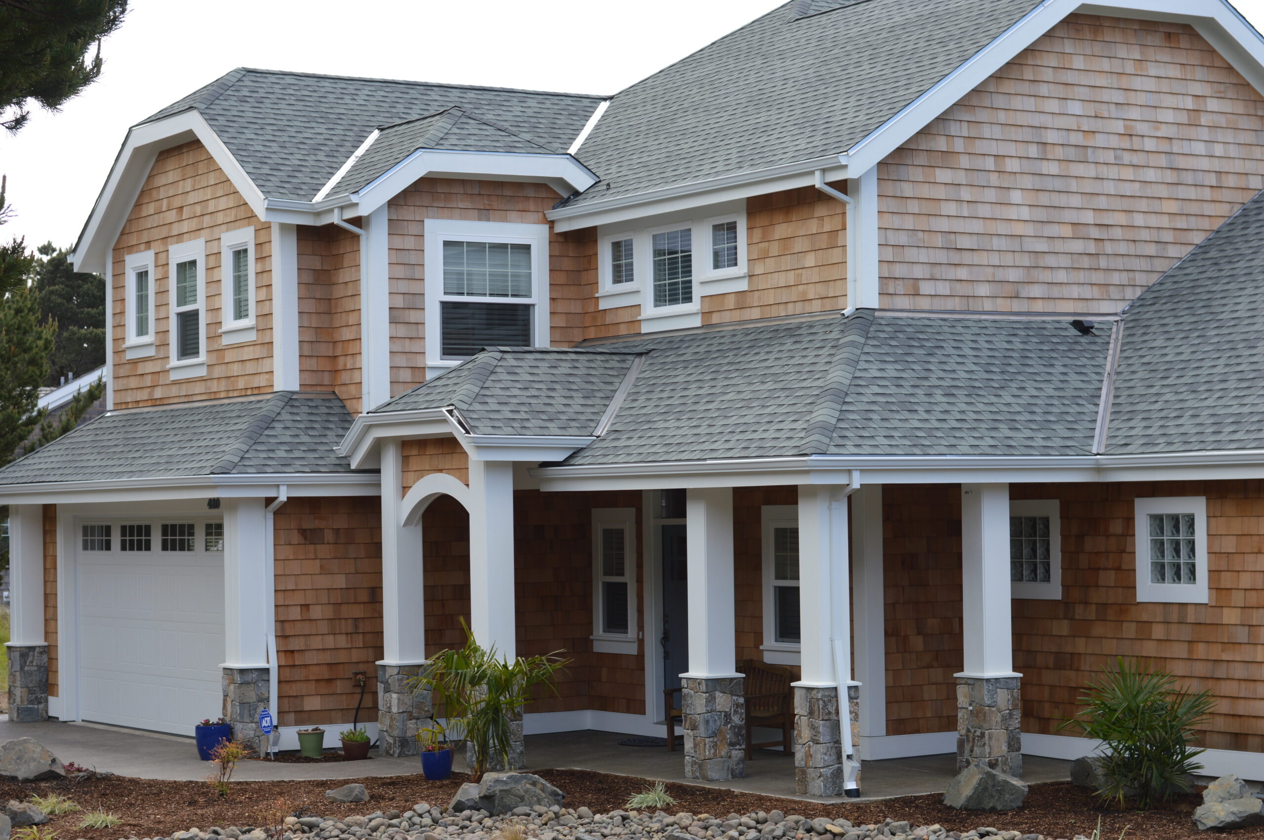 House with brown shingles.
